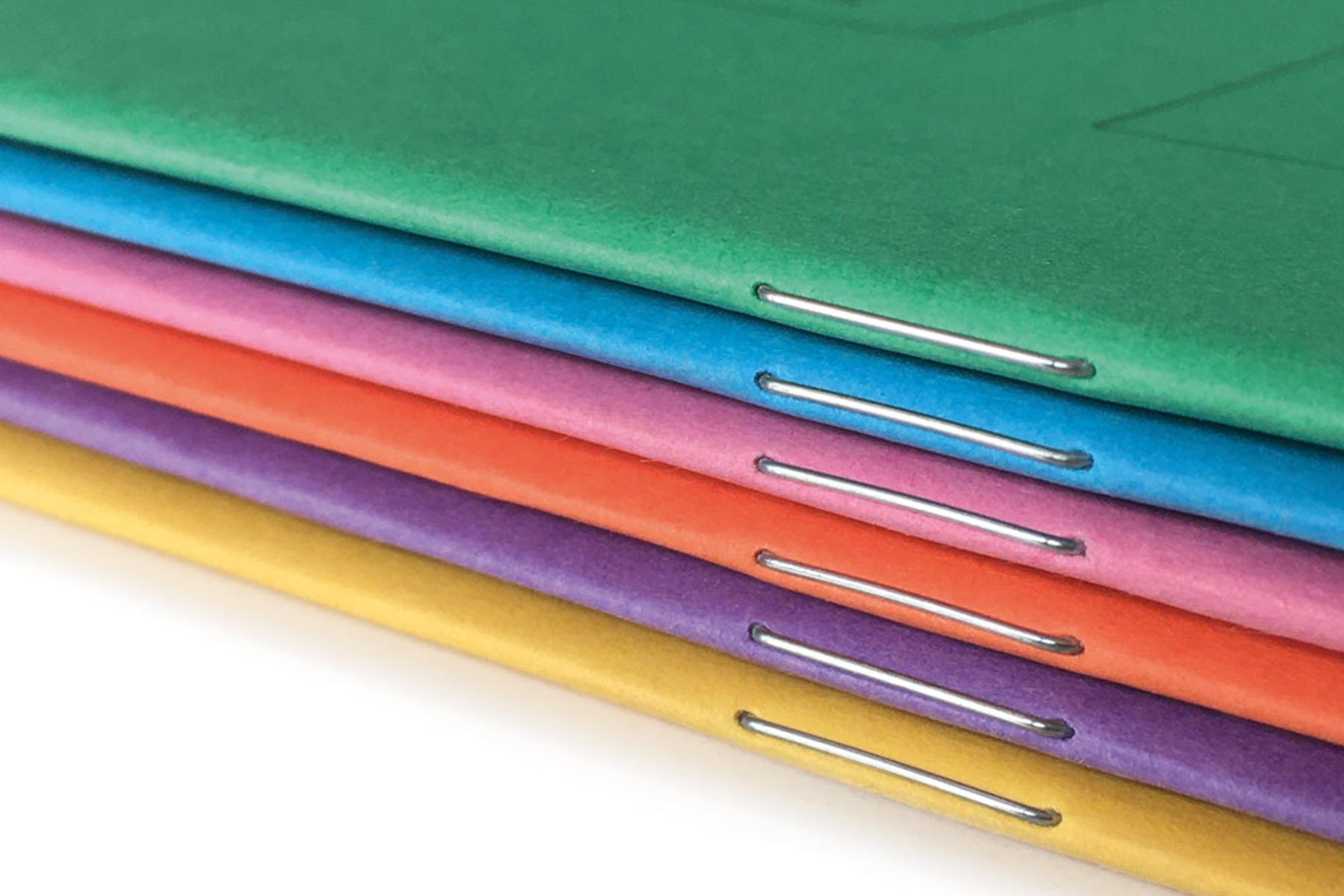 Custom school exercise books with colour coded covers for different subjects
