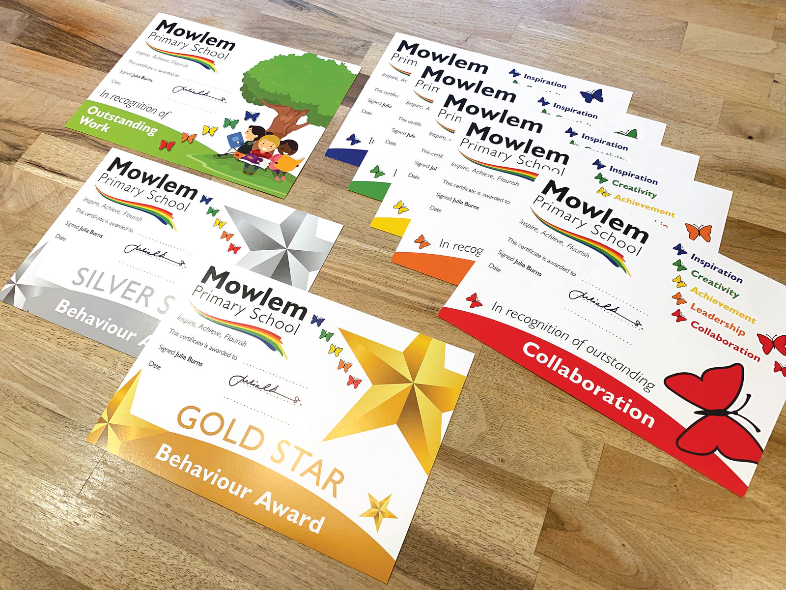 a range of printed school awards cards, postcards, certificates or achievement cards